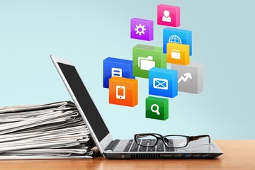 Laptop and black glasses  on   background.