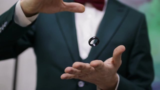 Trick Flying Ring. Hands magician show a trick with a ring.