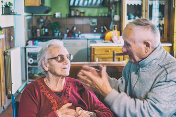 Elderly couple having a argument at home, blurred movements