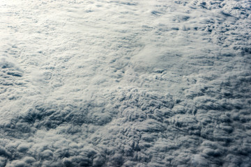 Top view of white clouds above the ground or water