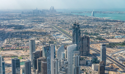 Amazing aerial view of Downtown Dubai and Marina on the background