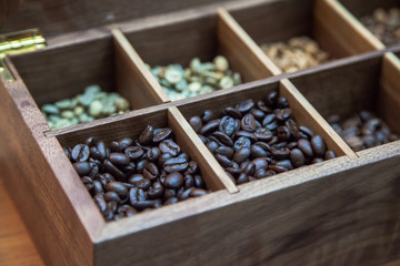 different coffee beans in a wooden case
