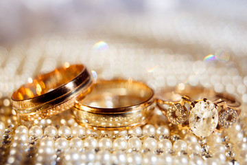 Wedding rings close up on shining background