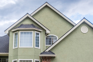 The top of the house or apartment building with nice window.