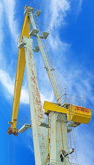 Fototapeta na wymiar old port crane on background sky