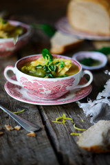 Soup with green vegetables and sea bass.