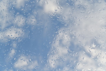 water drops on the glass against the background of clouds