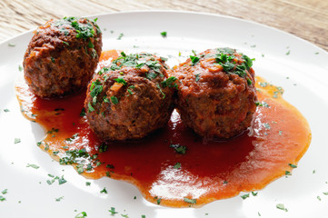 kofta in tomato sauce decorated with parsley