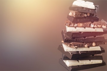 Close-up broken chocolate bar isolated on white background