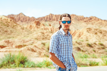 Naklejka premium the guy standing on a background of mountains