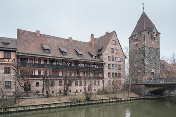 Fototapeta na wymiar Heilig-Geist-Spital (Hospice of the Holy Spirit) in Old Town Nuremberg. View from the Museum Bridge on the on the River Pegnitz - Nuremberg, Bavaria - Germany