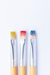 Three primary colors on white background.Red, blue and yellow color brushes.