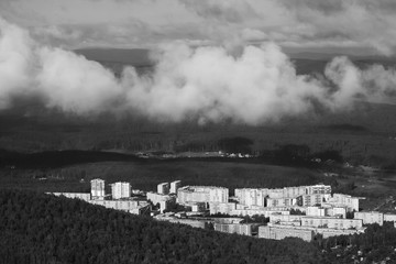 View of the houses of a small town from the top of the mountain. Black and white.