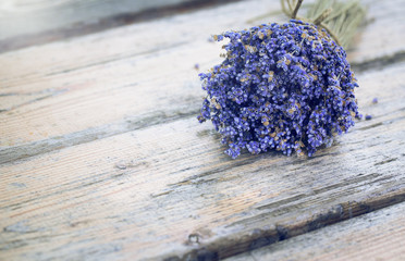 Bouquet of dried lavender on an old painted wooden background close up. French rustic country decor