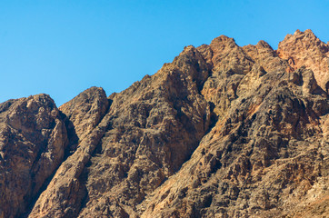 peaks of high rocky mountains against a blue sky in Egypt