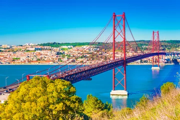 Fotobehang The 25th April Bridge (Ponte 25 de Abril) in Lisbon, Portugal. View from Almada © Travellaggio