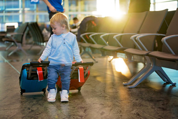 Children, traveling together, waiting at the airport to board the aircraft