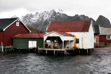 Traditional boat house in the water at Reine harbor on Lofoten Islands in Norway.