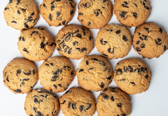 set of cookies with pieces of chocolate on white background