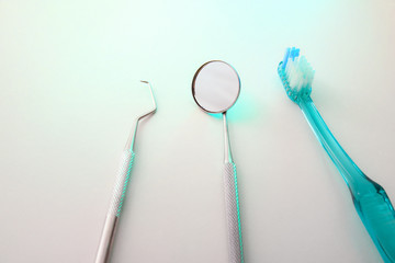 Dentist tools on table with green light top elevated