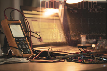 Abstract background with modern oscilloscope and electronic lab experimental, engineering educational use concept.