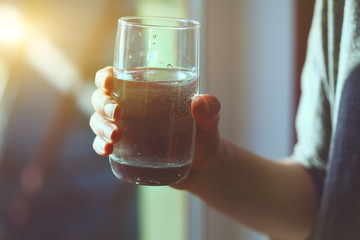 woman holding glass of water