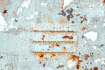 Texture of old rusty metal with air vents, painted white which became orange from rust in some places. Horizontal texture of cracked white paint
