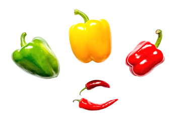 Red yellow and green peppers and chili close-up isolated on white background
