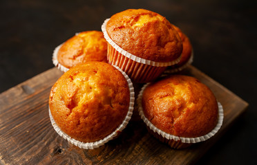 muffins with filling on a cutting board, against the background of dark concrete
