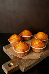 muffins with filling on a cutting board, against the background of dark concrete