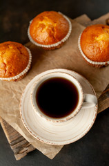 cupcakes and coffee on a background of concrete