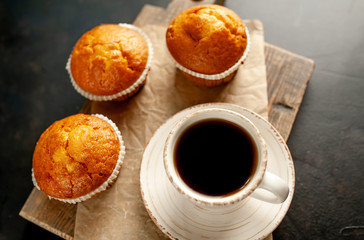 cupcakes and coffee on a background of concrete