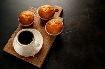 cupcakes and coffee on a background of concrete