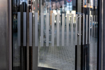close-up of modern secured glass door fragment at corporate business building. - Image