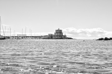 Blue harbormaster house restaurant and view over the beautiful sunny harbour of Marina del Sur in...