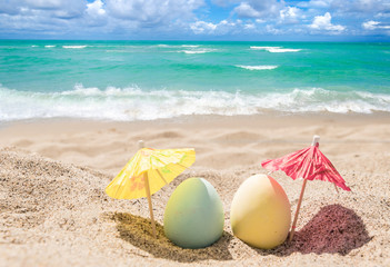 Happy easter lettering background with eggs on the sandy beach