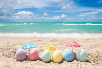 Happy easter lettering background with eggs on the sandy beach - 260333515