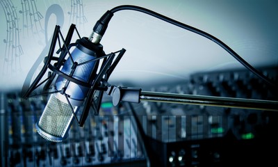 Microphone and  digital studio mixer  on background