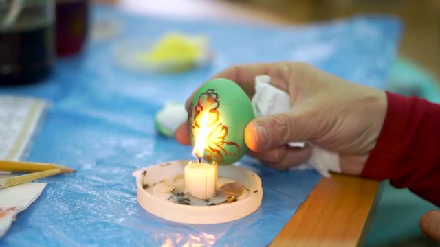 Woman painting easter eggs for holiday, easter preparation concept. cloce up