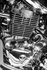 Fototapeta na wymiar Closeup of shiny chromed motorcycle engine with cylinder fins