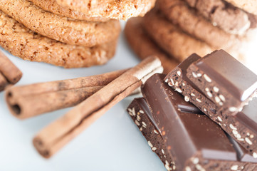 Various shortbread, oat cookies, chocolate chip biscuit and pieces of chocolate with seeds and nuts.