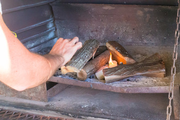 lighting firewood in barbecue 