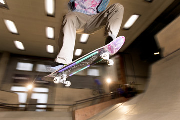 Action shot of young man doing skating trick flying in air at skateboard park, shot with flash © Seventyfour