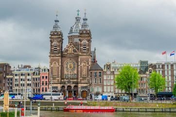 Canal and church of San Nicolas in front of the train station. Amsterdam netherlands holland