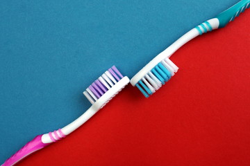 Two toothpastes on a red and blue background