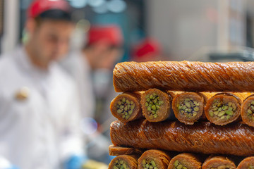 Chef making baklava with nuts at restaurant.