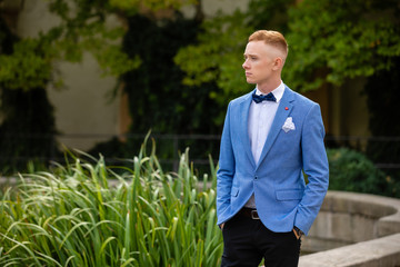 Charming groom in Wallenstein garden in Prague, Czech Republic