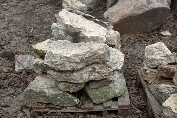 Large gray stones for landscape design on a wooden pallet