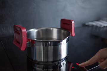 water in the pan is on the induction hob. Cooking at home