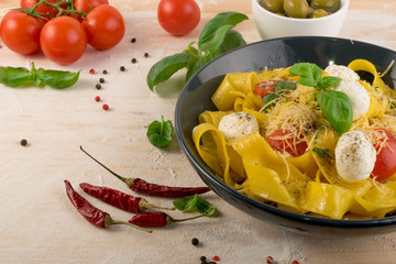Yellow italian pasta pappardelle, fettuccine or tagliatelle